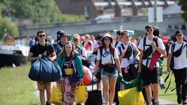 Festival goers walk along the towpath of the River Thames as they arrive for the Reading Festival at Richfield Avenue.
